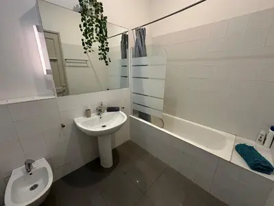 a bathroom with a sink and a toilet and a mirror at Habitaciones Roger in Barcelona