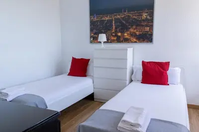 two beds with red pillows in a room at Apartments BCN Central-Colon in Barcelona