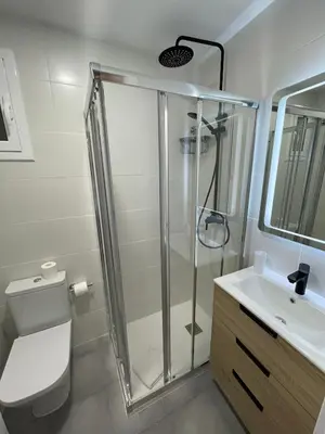 a bathroom with a shower and a toilet and a sink at Apartments BCN Central-Colon in Barcelona