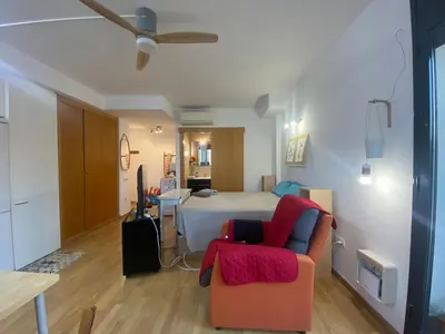 a room with a bed and a couch and a chair at Long Stays Terrassa Near Center in Terrassa