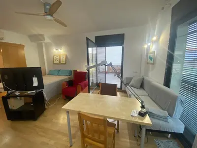 a living room with a couch and a table at Long Stays Terrassa Near Center in Terrassa