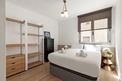 a bedroom with a large white bed and a window at Ola Living Poblenou Beach in Barcelona