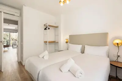 a bedroom with two beds with white sheets at Ola Living Poblenou Beach in Barcelona