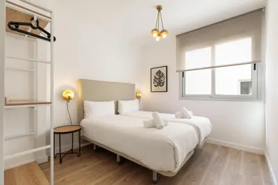 a bedroom with a large white bed and a window at Ola Living Poblenou Beach in Barcelona
