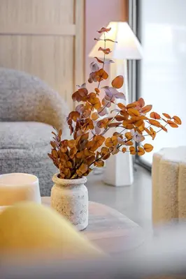 a vase with a plant in it on a table at Ola Living Poblenou Beach in Barcelona