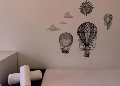 a bedroom with three hot air balloons on the wall at Apartments BCN Central-Drassanes in Barcelona