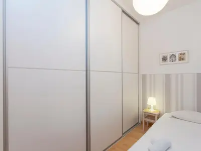 a bedroom with sliding glass doors and a bed at RentBCN Rambla Catalunya Apartment in Barcelona