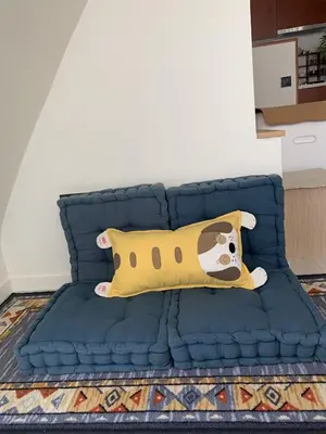 a blue bed with a pillow with a dog on it at Vacation house with garden in the foothills in Barcelona