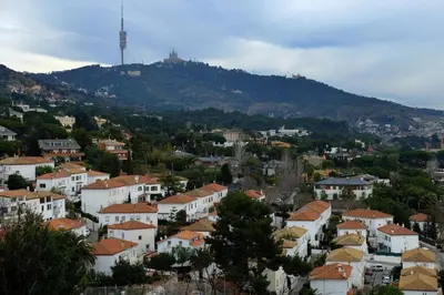 a view of a town with a mountain in the background at Vacation house with garden in the foothills in Barcelona