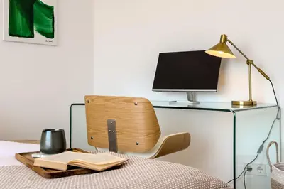 a desk with a chair with a computer on it at Sagrada in Barcelona