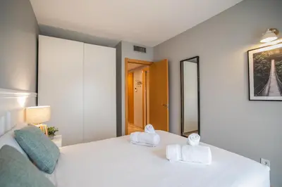 a bedroom with a white bed with towels on it at 13MAL1077- Magnific 2BR flat in Barcelona