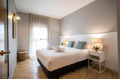 a bedroom with a large white bed and a window at 13MAL1077- Magnific 2BR flat in Barcelona