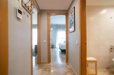 a hallway leading to a bedroom with a bed at 13MAL1077- Magnific 2BR flat in Barcelona