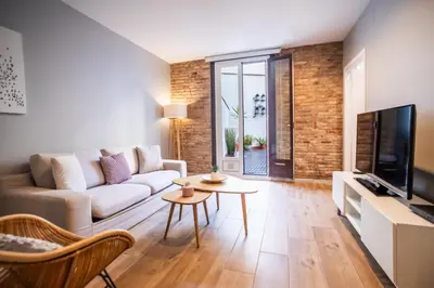 a living room with a couch and a tv at B3MAL1081- New 2BR flat with private terrace in Barcelona