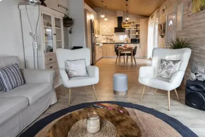 a living room with a couch and two chairs and a table at Hogar con encanto y personalidad in L'Ametlla del Vallès