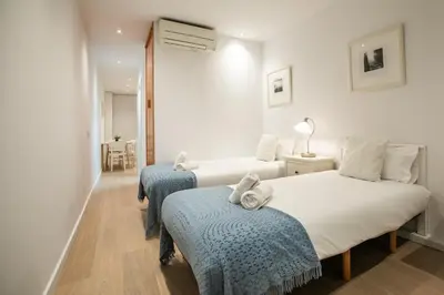 a bedroom with two beds with towels on them at E4lle1031 - Studio next to Plaza Espanya in Barcelona