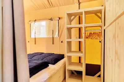 a bunk bed and a ladder in a room at Glamping Costa Dorada in Vilanova i la Geltrú