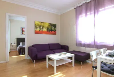 a living room with a purple couch and a table at Classbedroom Barcelona Sagrera Apartment in Barcelona