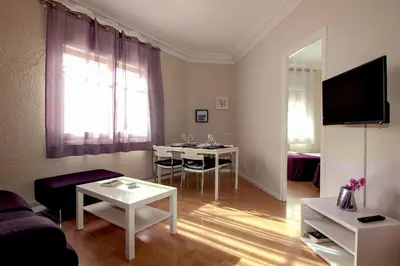 a living room with a couch and a table at Classbedroom Barcelona Sagrera Apartment in Barcelona
