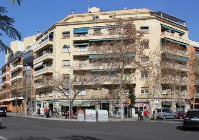 a tall building on a city street with cars parked in front at Classbedroom Barcelona Sagrera Apartment in Barcelona