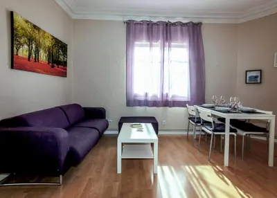 a living room with a purple couch and a table at Classbedroom Barcelona Sagrera Apartment in Barcelona