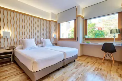 a bedroom with two beds and a window at Bonanova Suite in Barcelona
