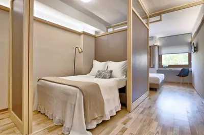a bedroom with a bed and a large mirror at Bonanova Suite in Barcelona