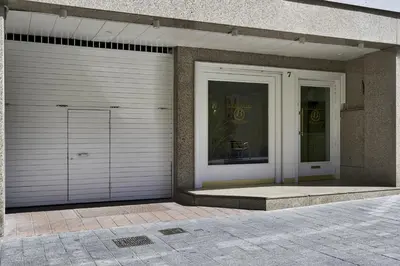two garage doors on the side of a building at Bonanova Suite in Barcelona