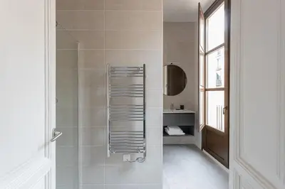 a bathroom with a shower with a metal towel rack at Serra house premium apartments in Barcelona
