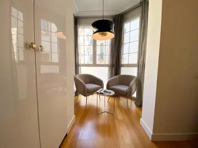 a living room with two chairs and a pendant light at Spacious Elegant on Avenue Diagonal By MyRentalHost in Barcelona