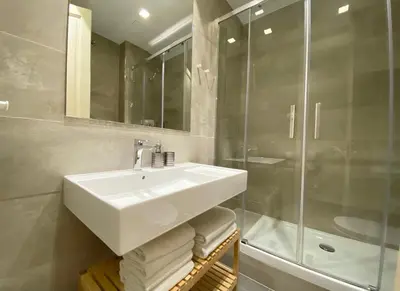 a bathroom with a white sink and a shower at Spacious Elegant on Avenue Diagonal By MyRentalHost in Barcelona