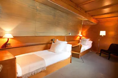 a bedroom with two beds and a desk and lamp at Villa Gaudi in San Justo Desvern
