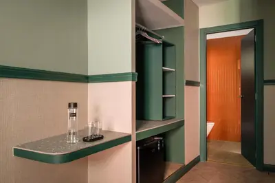 a bathroom with green and white walls and a counter at BYPILLOW Twenty in Barcelona