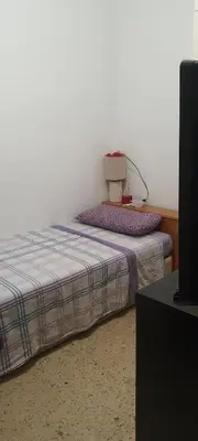 a bedroom with a bed with a box on it at Estudio, privado e independiente in Hospitalet de Llobregat