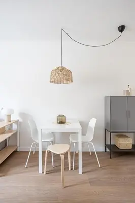 a white dining room with a white table and chairs at Modern 1 bedroom apartments near Parallel in Barcelona