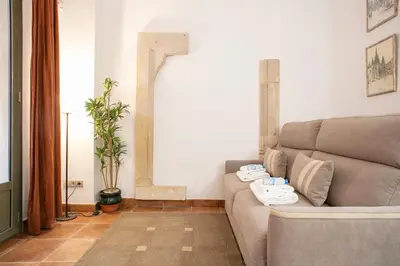 a living room with a couch with towels on it at Alcam Dali in Barcelona