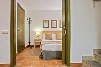 a bedroom with a bed and a table with a lamp at Alcam Dali in Barcelona