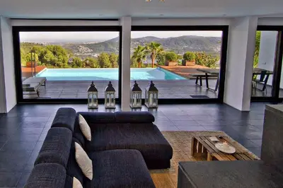 a living room with a couch and a swimming pool at Holiday Home Alexander Plana in Pallejá
