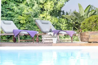 a couple of beds sitting next to a pool at Holiday Home Alexander Plana in Pallejá