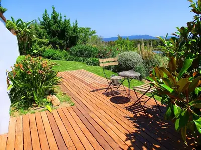 a wooden deck with a bench and a chair at Holiday Home Alexander Plana in Pallejá