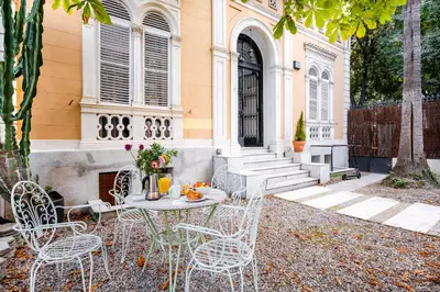 a table and chairs in front of a building at Canela Homes BARCELONA PERMANYER in Barcelona