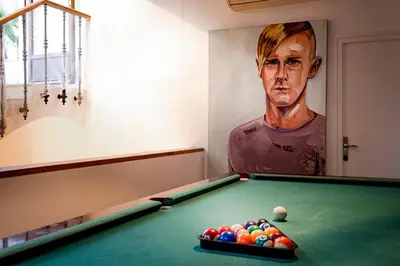 a room with a pool table and a painting of a man at Canela Homes BARCELONA PERMANYER in Barcelona