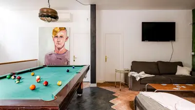 a living room with a pool table and a couch at Canela Homes BARCELONA PERMANYER in Barcelona