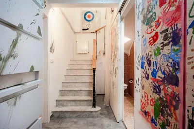 a hallway with stairs and paintings on the walls at Canela Homes BARCELONA PERMANYER in Barcelona