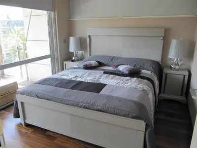 a bedroom with a bed and a large window at Torre Forum in Sant Adria de Besos