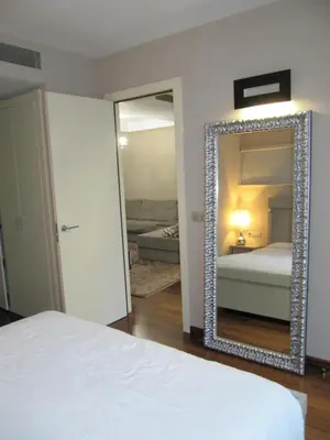 a bedroom with a large mirror and a bed at Torre Forum in Sant Adria de Besos
