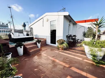 a patio with a couch on top of a house at Diamond Rooftop & private terrace sea views in Barcelona