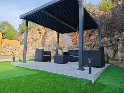 a gazebo with two couches on a lawn at Venecia relax in Vallirana