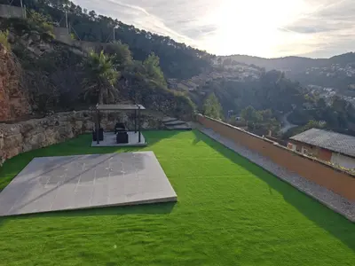 a tennis court on a green field of grass at Venecia relax in Vallirana