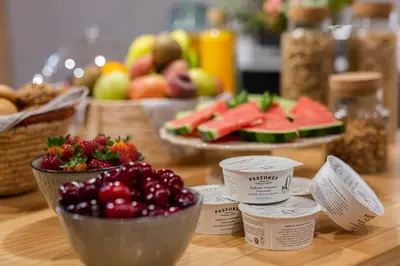 a table topped with bowls of fruit and other foods at Hotel Margot House Barcelona in Barcelona